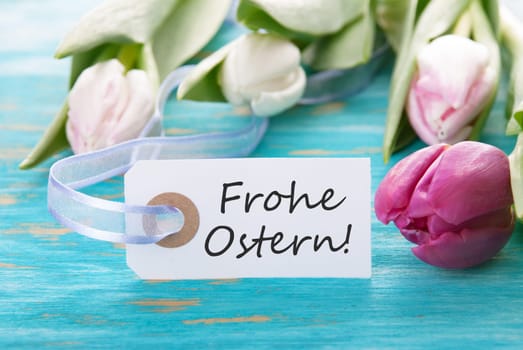 Tag with the german words Frohe Ostern which means Happy Easter and tulip on turquoise background