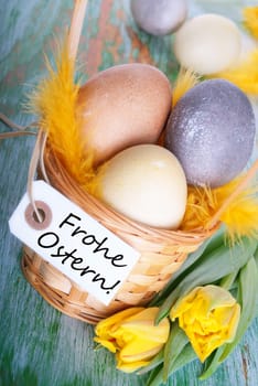 Eggs in a Basket with a Label with the German Words Frohe Ostern which means Hapy Easter