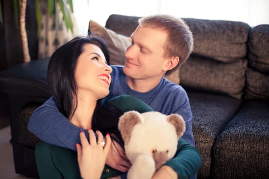 Happy young married couple in their house on valentine's day