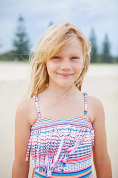 Portrait of cute young girl in swimming suit at the beach