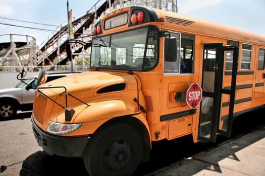 School bus parked while the kids visit the  theme park of Coney Island