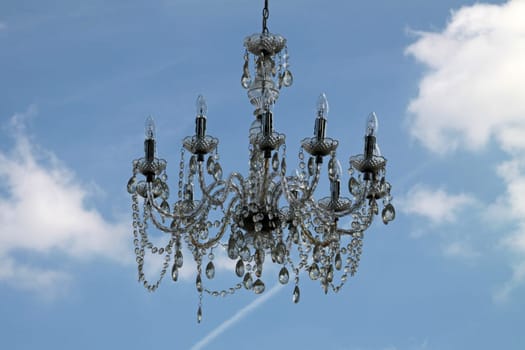 A chandelier hangs from the sky