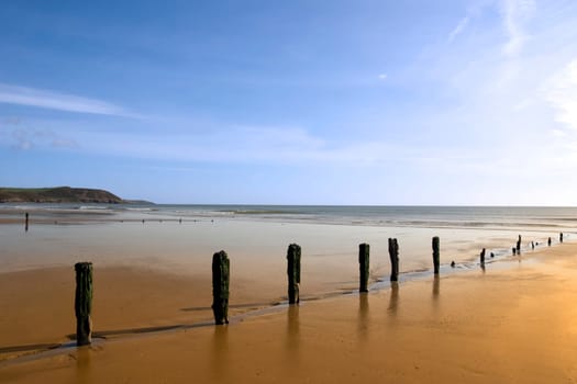 sunshine over the beach breakers in Youghal county Cork Ireland on a summers day