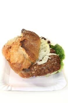 a bun with minced steak,white cabbage salad and salad