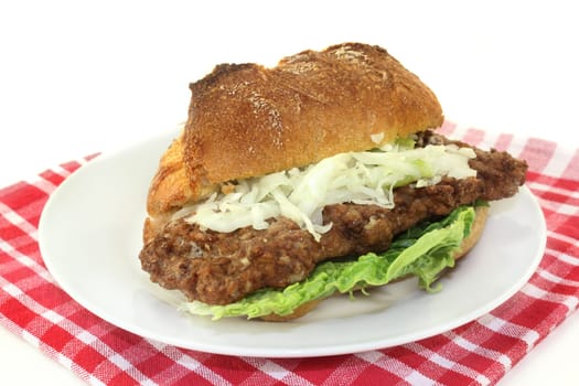 a bun with minced steak,white cabbage salad and salad