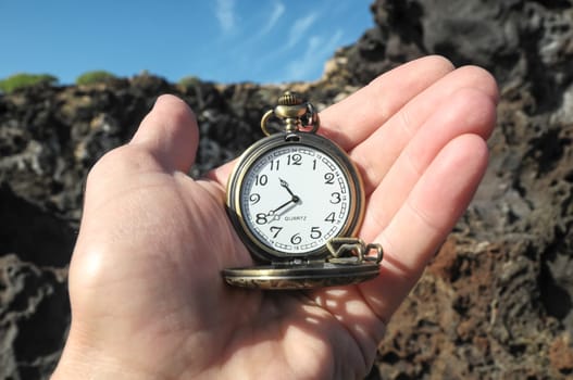 Time Concept Classic Vintage Pocket Clock on the Volcanic Rocks