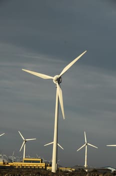 Eletric Power Generator Wind Turbine over a Cloudy Sky