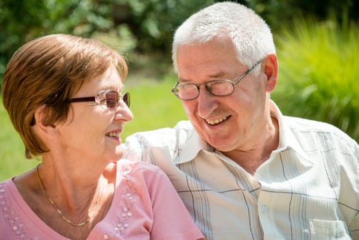 Portrait of smiling happy senior couple - outdoor on sunny day