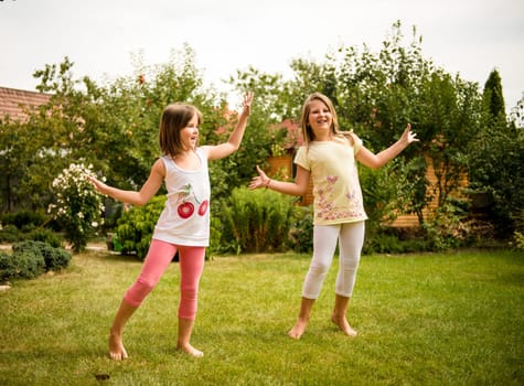 Active childhood - happy child dancing outdoor in backyard