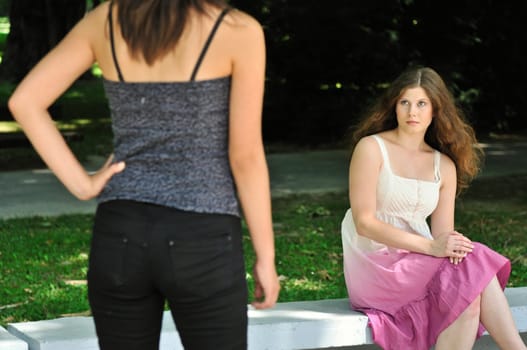 Modern woman (torso visible only) looking at another one with innocent look