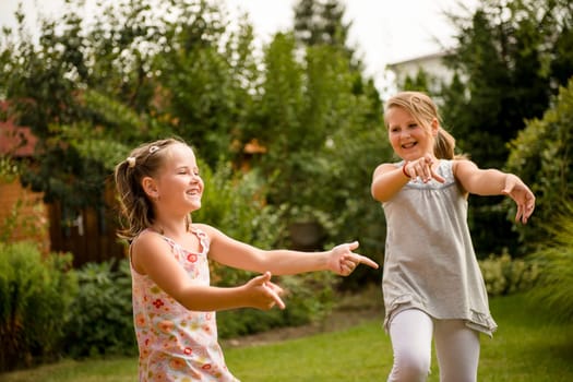 Active childhood - happy child dancing outdoor in backyard