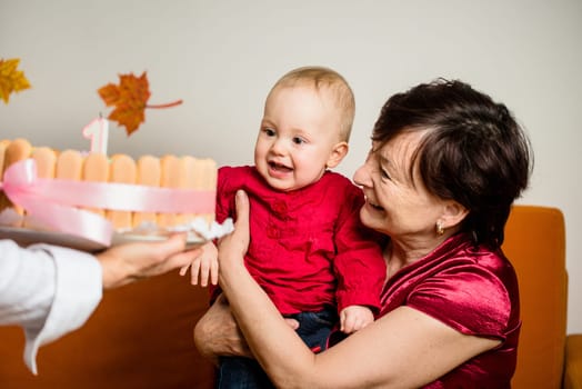 Grandmother with her baby grandchild celebrating first birthday