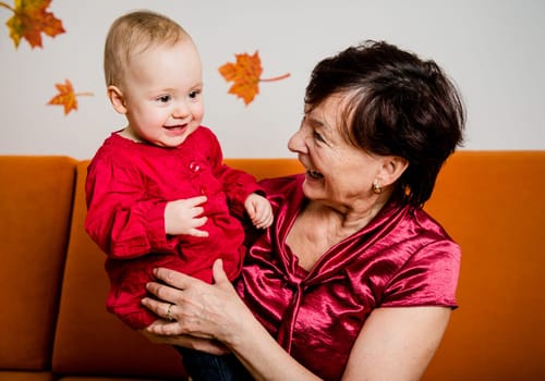 Indoor portrait of grandmother with her grandchild