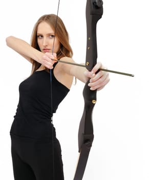 Beautiful woman concentrating and aiming with bow and arrow