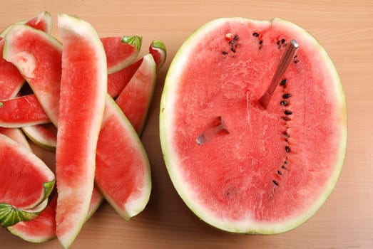 Fresh watermelon with eaten slices on table
