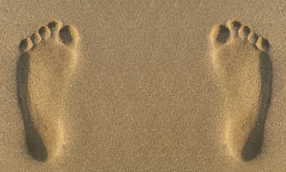 Two parallel footprints in sand