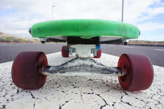 Vintage Style Longboard Black Skateboard on an Empty Asphalt Desert Road
