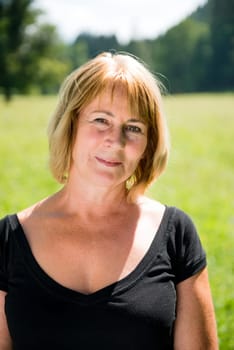 Portrait of attractive senior woman - outdoor on sunny day
