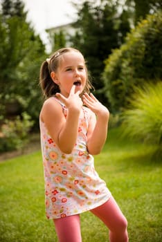 Active childhood - happy child dancing outdoor in backyard