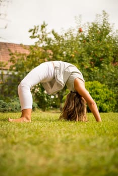 Active childhood - little child exercises outside in backyard