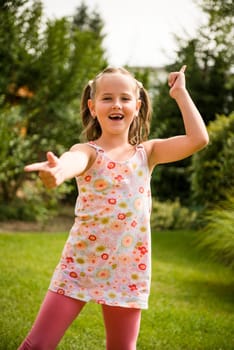 Active childhood - happy child dancing outdoor in backyard