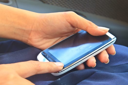 touchscreen phone in the hands of a young girl