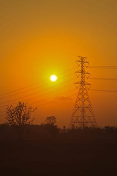 High voltage power pylons in sunset scene twilight