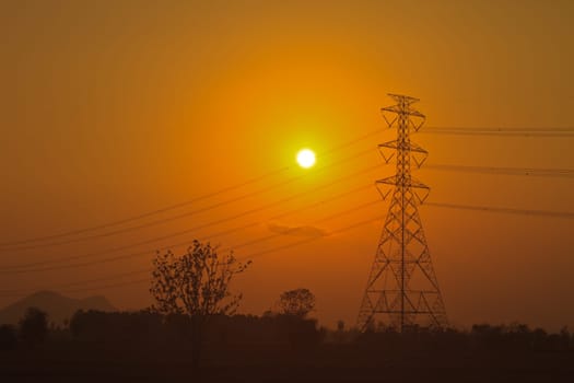 High voltage power pylons in sunset scene twilight