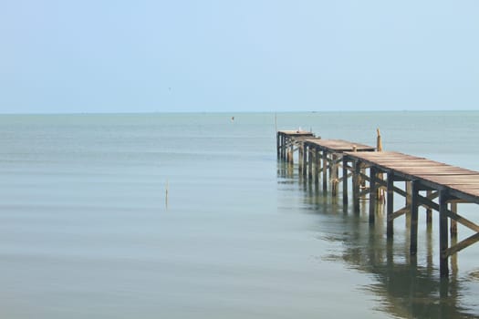 Wooden bridge into the sea, summer in Thailand