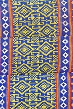 Thai Esan traditional pillows have a specific shape like cube and contain the pure cotton inside. The pillow surface has a specific weaving pattern and gaudy color. Handcraft art.