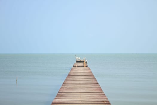 Wooden bridge into the sea, summer in Thailand