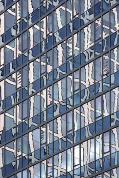 The abstract photograph of high-rise reflections in a high-rise façade.