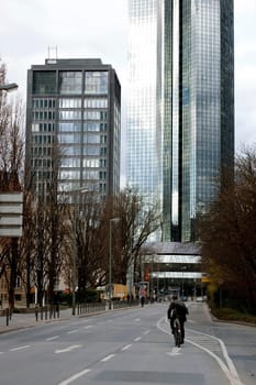 Frankfurt,Germany - February 19,2014: A cyclist rides on a main road towards the financial district on February 19,2014 in Frankfurt.