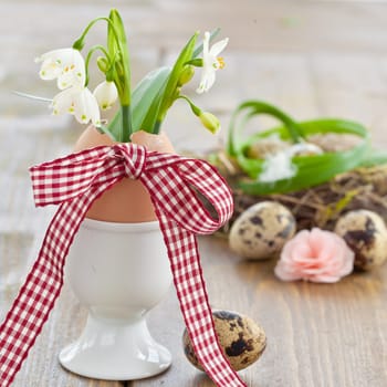 Fresh snowdrops and eggshell with big bow