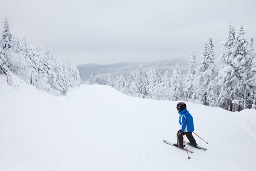 Mont-Tremblant, Canada - February 9, 2014: A boy is skiing down an easy slope at Mont-Tremblant. Mont-Tremblant Ski Resort is acknowledged, by most industry experts, as being the best ski resort in Eastern North America.
