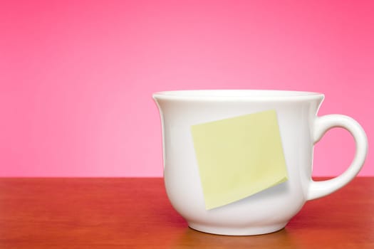 Coffee cup with empty sticky note for your text