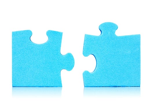 Connection metaphor. Two  pieces of blue puzzle on white background
