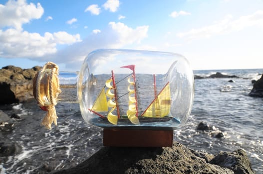 Ancient Spanish Sailing Boat in a Bottle near the Ocean