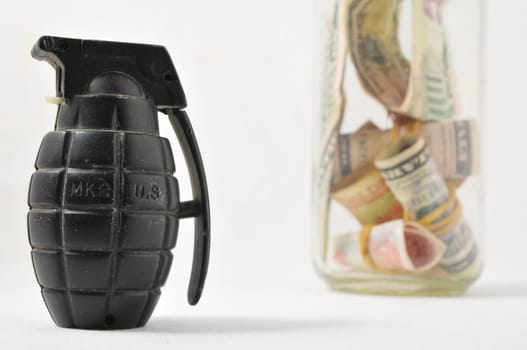 Money for War Concept Hand Grenade and Currency