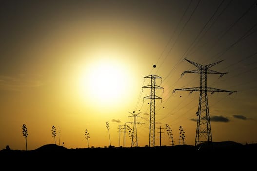 Electric Power Line Pylon over a colored Sunset