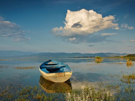 Boat on sunset in the lake