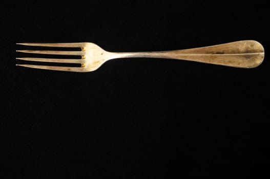 Ancient Vintage Silver Flatware on a Black Background
