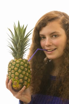 A young pretty woman holds a pineapple with a straw in her hand
