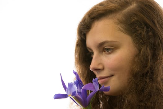 A young beautiful woman holds a flower in her hand