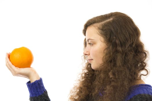 Eine junge hübsche Frau hält eine Orange in der Hand