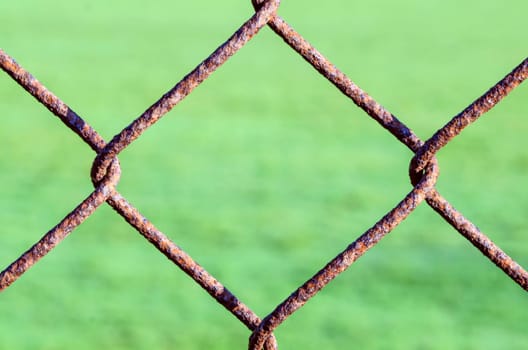Detail of an old rusting chain link fence