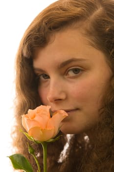 A young beautiful woman holds a rose in her hand