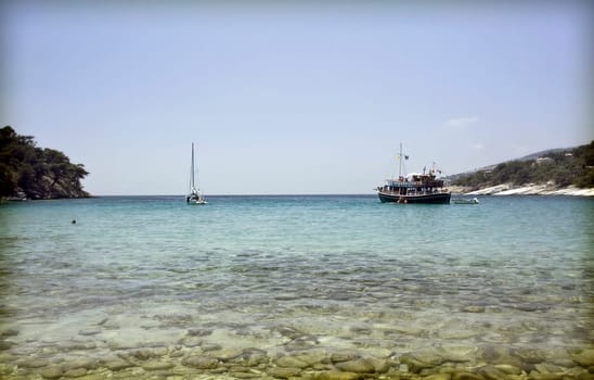 Vintage photo of lonely boat in a beautiful clear water lagoon