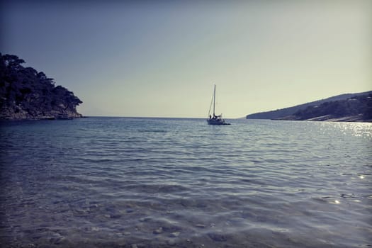 Vintage photo of lonely boat in a beautiful clear water lagoon