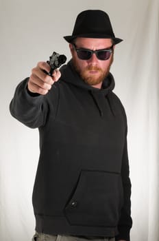 Black Dressed Young Man Holding a Pistol Gun